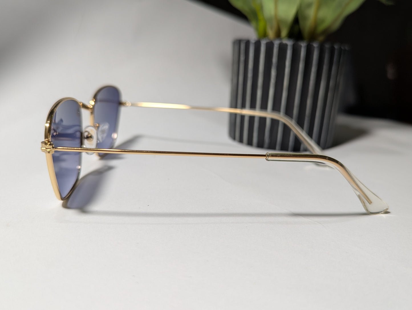 geometric luxe: gold frame angular sunglasses with twilight tint