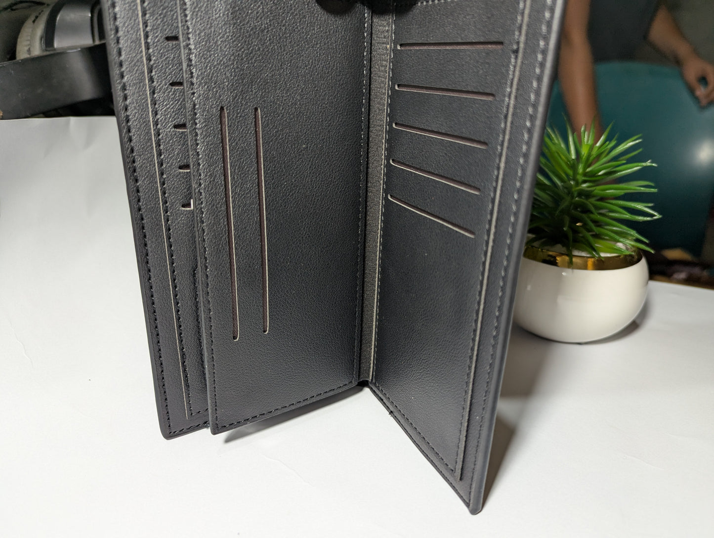 The Gotham Traveler: Sleek Black Leather Trench Wallet - Emblem Edition