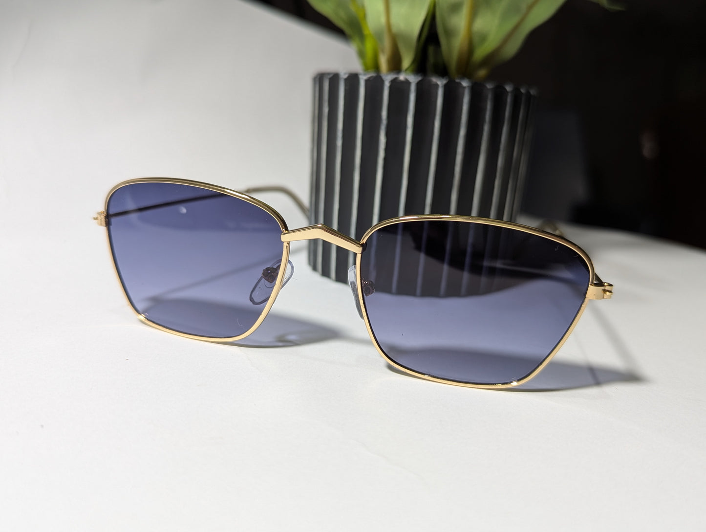 geometric luxe: gold frame angular sunglasses with twilight tint